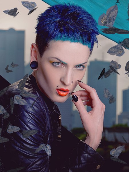 Short clipped hair with a blue hair color