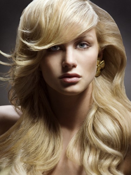 Long flowing blonde hair styled into smooth cascading waves
