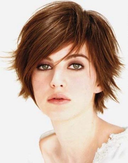 Feminine short tomboy haircut with outward styled tips