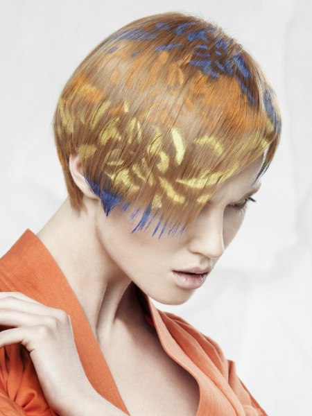 Hair color sprayed on the hair through a template or stencil