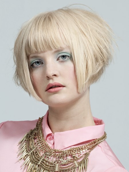 Short bob hairstyle and a buttoned-up blouse collar
