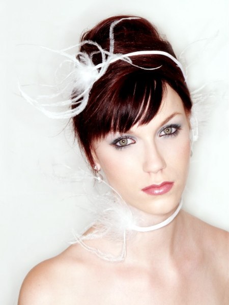 Turban up-do wedding hair with a feathered ribbon