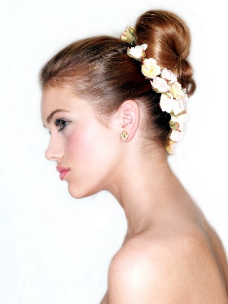 Hair styled in a bun with flowers