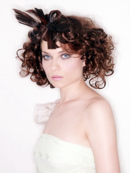 Romantic hairstyle with curls and a bow hairpiece