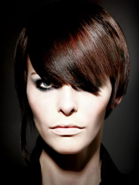 Short hairstyle with an asymmetric side-lock and a smooth shiny finish