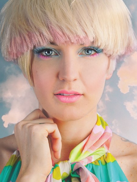 Short bowl shaped cut in a blonde with strawberry pink hair color