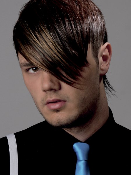 Modern men's hairstyle with razor-cut texturing and a long fringe