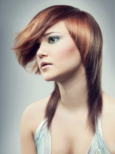 Steeply tapered hair with tips that reach below the shoulders