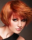 Short coppery red hair with side swept bangs