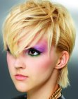 Punky short hairdo with pointed bangs and slicked back sides