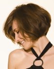 Side view of a short stacked bob with a curve in the nape