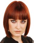 Mid-neck bob hairstyle with full bangs for red hair