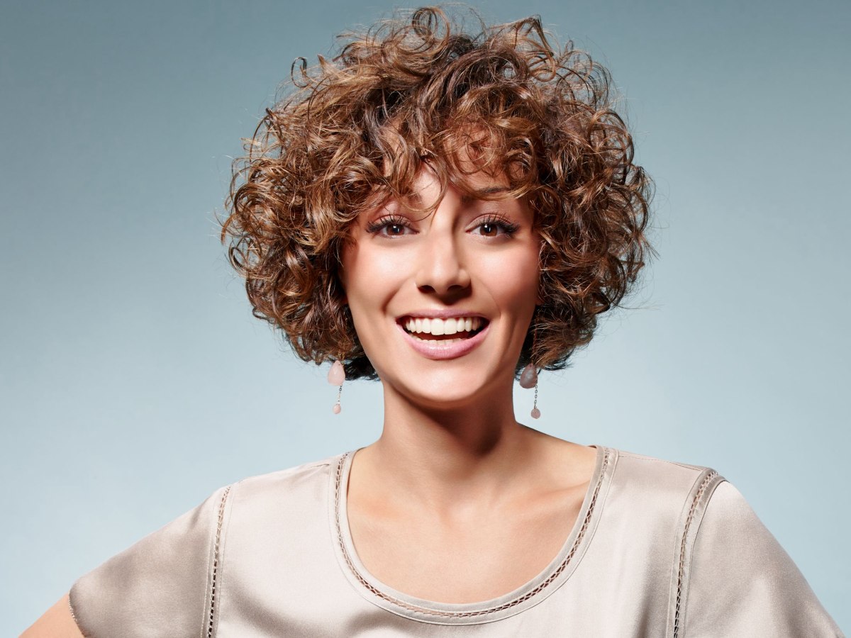 Fresh short hairstyle with happy small curls and a round shape
