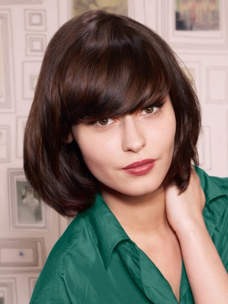 French bob hairstyle with curved bangs and a silk blouse
