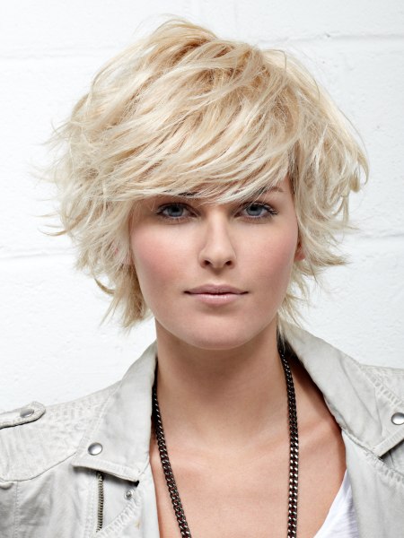 Short blonde haircut with long layers and volume