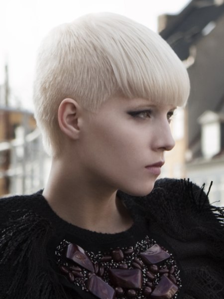 Short blonde women's haircut with buzzed sides