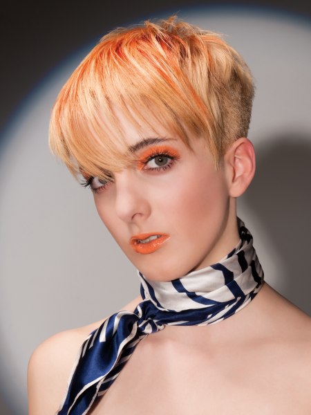 Buzzed pixie cut with orange hair color