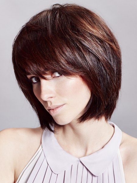 Youthful brown bob haircut that follows the curve of the head