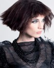 Trapeze shape bob with teased hair and raised sides
