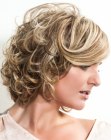 Easy to wear blonde hairstyle with curls and a sleek front