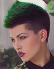 Very short clipper cut hair with a green accent color