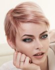 Pixie cut with a pink tint and short side bangs