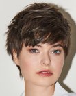 Trendy pixie hairstyle with bangs and soft highlights
