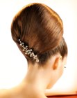Updo with a large chignon and a studded barrette