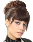 Up-style with a simple bun and bangs