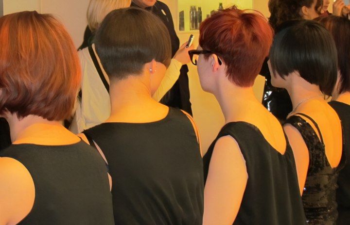 Back view of short hair models at a hair show