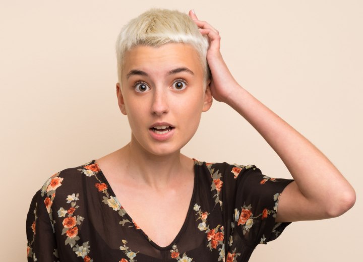 Girl who is in shock when seeing her new short haircut