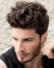Neat masculine hairstyle with short back and sides and longer top hair