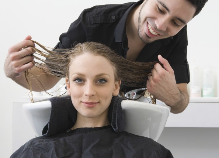 Hairdresser who is inspecting a client's hair color