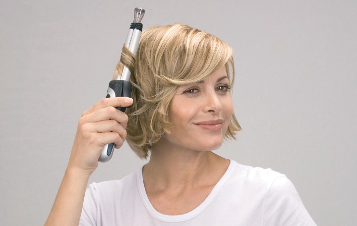 Roll hair strands onto a curling iron