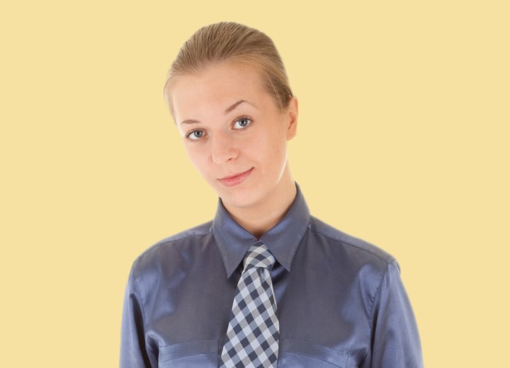 Woman wearing a silk blouse and a necktie for the office