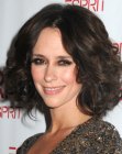 Jennifer Love Hewitt's medium length hairstyle with waves and curls