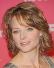 Josie Foster's neck length hairstyle with layers and long bangs