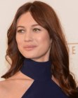 Olga Kurylenko wearing her hair below the shoulders and curled