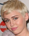 Miley Cyrus with her hair in a pixie cut with buzzed sides and back