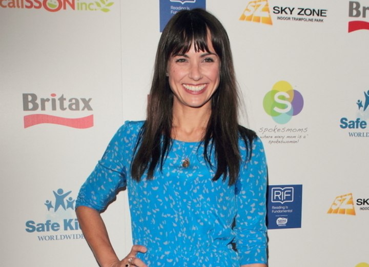 Constance Zimmer wearing a blue quarter sleeved dress