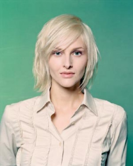 Haircut styled to combat the prominence of a long slender nose