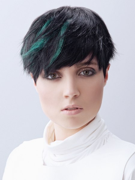Black pixie cut with green hair color splahes