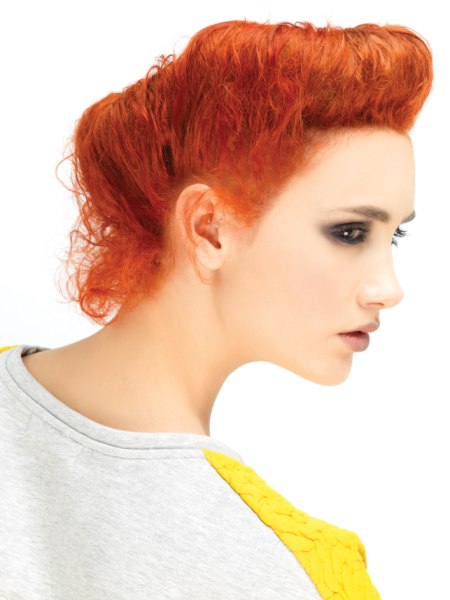 Vintage updo with a 1950s quiff and a striking copper hair color