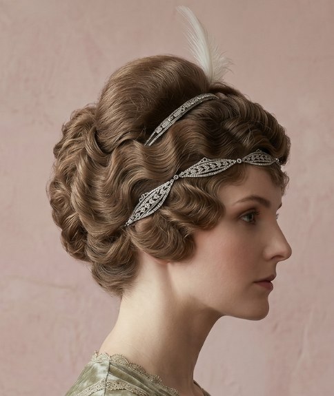 1910s updo with a headband and a feather