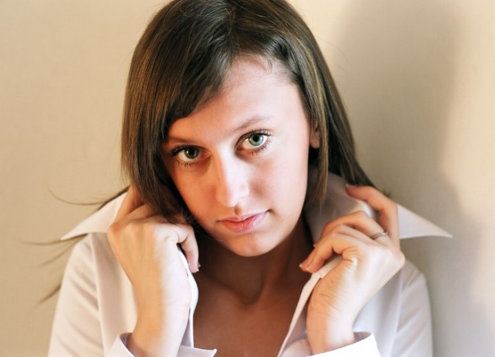 Woman wearing her buttoned shirt with the collar turned up