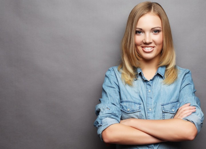 Woman wearing a buttoned shirt with the sleeves pushed up