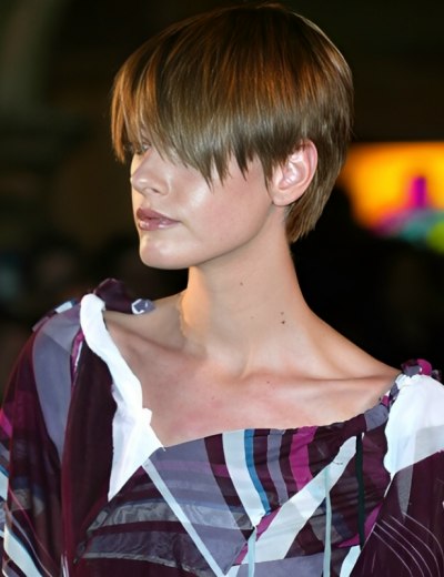 Modern pixie hair cut with bangs, layered in the back and 