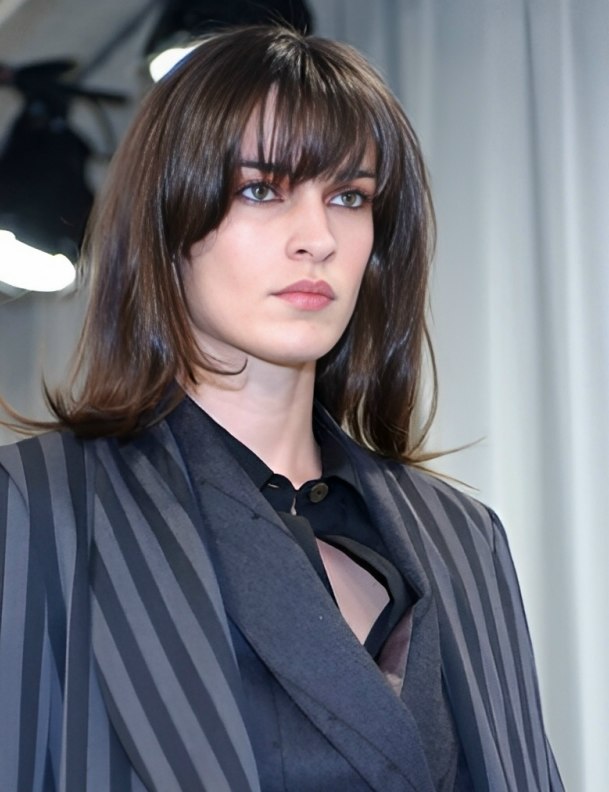 Chic long razor-cut hair with fullness and a gentle curve