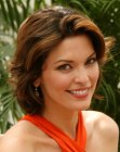 Alana De La Garza wearing a mid-length hairstyle with layers