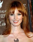 Alicia Witt wearing her long red hair with layers and flipped sides